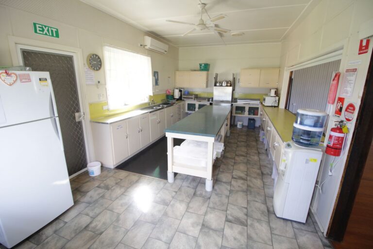 The Hub's kitchen showing a full-height fridge beside the preparation bench